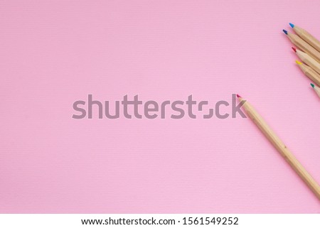 Back to school concept. School and office supplies on office table. Flat lay with copy space. Creativity inspiration education concepts with pencil and cup on pink pastel color background. minimal