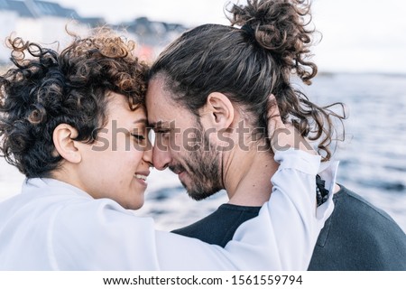 Stock photo of a young couple hugging each other's faces. Lifestyle