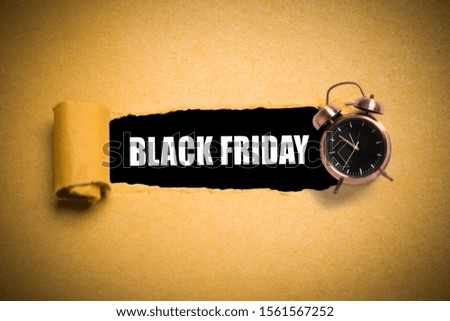 torn paper reveals "Black Friday" on black background