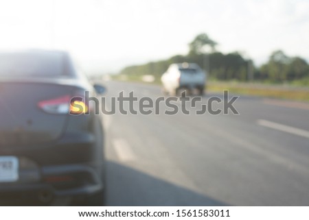 burred picture,The car is turning on the right turning light to enter the main road.