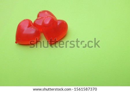 red heart on green background
