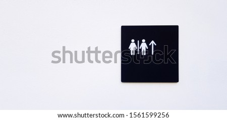 Restroom, toilet or washroom sign or symbol on white wall and give direction and way to go straight with copy space