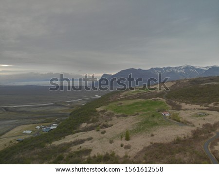 Iceland drone picture of glacier with clouds and mountain background