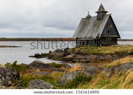 Old house by the sea in cloudy weather, autumn picture landscape.