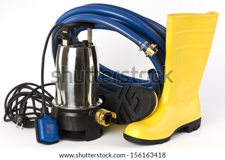 Submersible pump, rubber boots and water hose pictured on a white background.