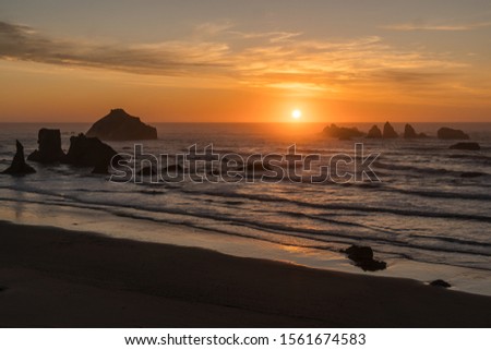 Beautiful Sunset on Ocean Beach with Waves and Rocks.