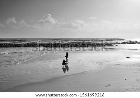 Italy, Sicily, Mediterranean Sea, Marina di Ragusa (Ragusa Province), photographer taking pictures of a woman on the beach