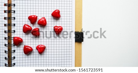 red hearts on a checkered leaf. Heart scatter falling on white background. Red and crimson folded paper cut hearts. Sweet love symbols. Happy Valentine's Day, my love