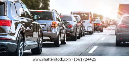Car rush hours city street. Cars on highway in traffic jam Royalty-Free Stock Photo #1561724425