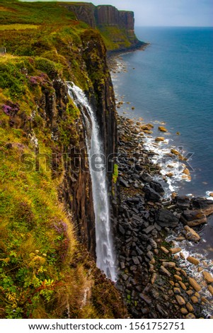 Photo of a landscape, waterfall falling from a cliff, in the Scottish Highlands