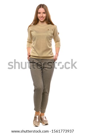 Girl in brown trousers, golden sweater and shoes. Beauty and fashionable look of fashionable model. Textile, design, clothes, fashion concept, isolated on white background.