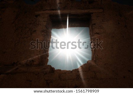 Sun rays passing trhough a window of an abandoned building