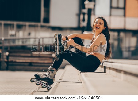 Teenage woman girl riding roller skates during summertime through city having great time