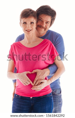 Pregnant couple expecting baby smiling cheerful on white