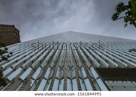 A low angle shot of a high-rise building under the breathtaking cloudy sky
