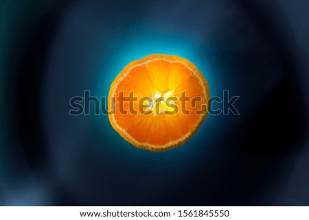 Slice of mandarin on a blue background, top view.