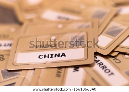 China word on a yellow card, shallow depth of field. Multiple cards visible out of focus. Travel to China concept,chinese products made in China