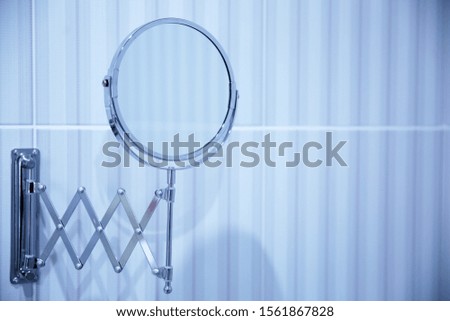 Round mirror in the bathroom. Abstract bathroom background. Photo Close-up