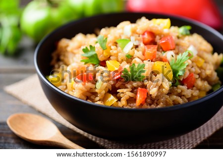 Fried rice with vegetables in a bowl, Asian food Royalty-Free Stock Photo #1561890997