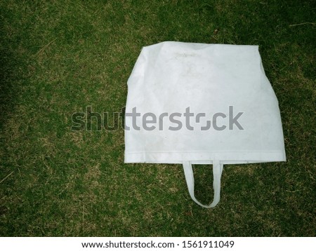 isolated Eco Friendly Bag, Non Woven white Bag, Polypropylene Reusable Bag on green