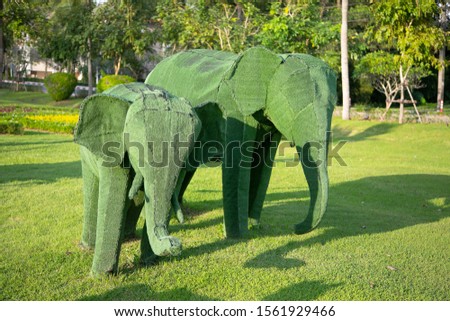 Giant animal sculptures made from grass.