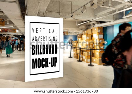 Mock up perspective large blank vertical billboard with clipping path on walkway of subway, blurred many people walking, empty space for advertising or information, advertising concept