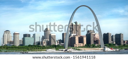 St Louis Gateway Arch panorama skyline, office buildings, on Mississippi river waterfront with tugboat, transportation, landmark, sightseeing, travel, monument Royalty-Free Stock Photo #1561941118