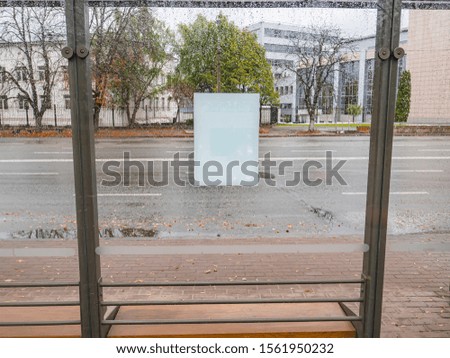 White sheet of paper on wet glass from the rain. Place for text.
