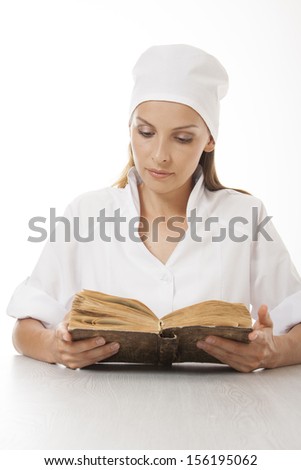 Woman doctor or nurse reading old book, isolated on white background