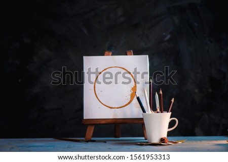 Coffee for inspiration concept, cups, and pencils on a dark background with copy space