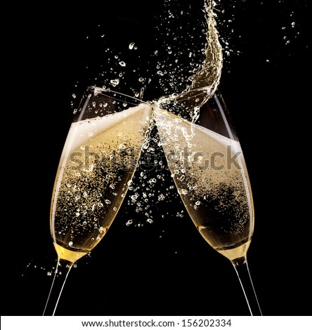 Glasses of champagne with splash, isolated on black Royalty-Free Stock Photo #156202334
