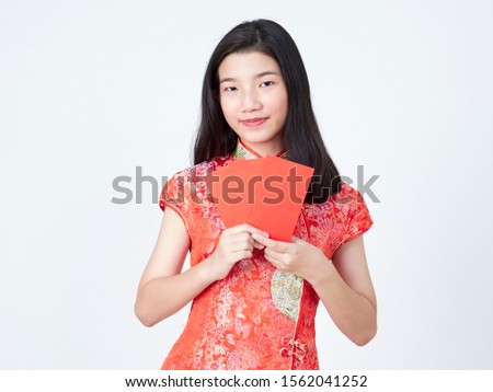 Portrait of asian woman in traditional chinese dress holding red envelope isolated on white background. Chinese new year. Concept New Year Sale.