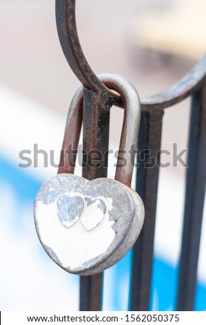 Padlocks newlyweds in the form of love hearts on the iron structure.