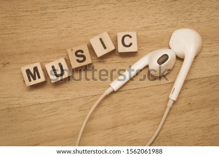 Music word cube on wood background ,English language learning concept