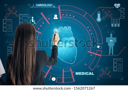 Cardiology and science concept. Businesswoman using creative glowing medical interface on blue background