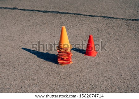 Collected cones on the site for bikers.  Traffic cones on the training ground in the driving school. Circuit for students in a motorcycle school.  Training courses driving a car