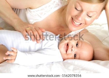 baby with his mother and been cared for after having a good sleep in bed at home with people stock photography stock photo