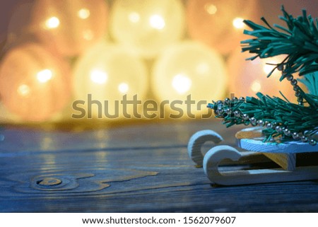 Christmas tree on the sled on the christmas background with blurred lights. Waiting xmas