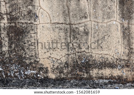 Destroyed dyed plaster mortar wall cellar farm house. Old dirty urban exterior granite facade. Scary ruined structure background. Uneven worn stone texture. Outside spooky oxide blots for 3d design