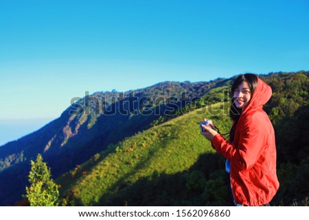 Happy traveler Asian woman tracking mountain.