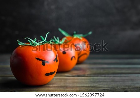 Angry, sad, fear. negative emotions on tomatoes. copy space