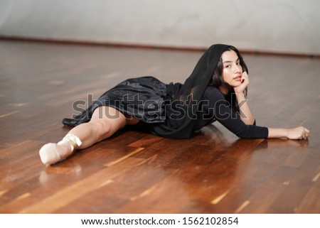 portrait of dancer girl in black dress in the room