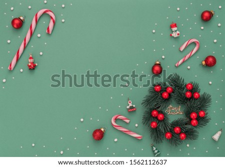 Christmas background with Christmas wreath with berries and Xmas decorations. New Year greeting card. Flat lay style. 