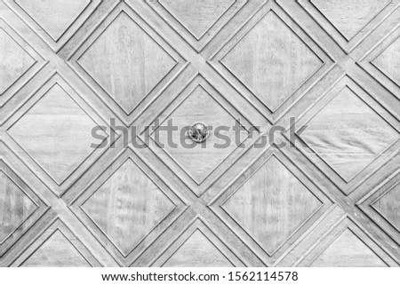 
Wooden white ceiling with repeating patterns.