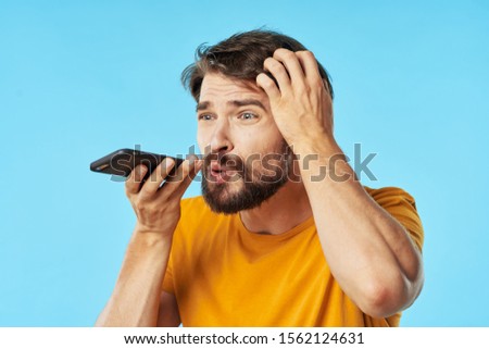 A man talking on the phone blue background communication device