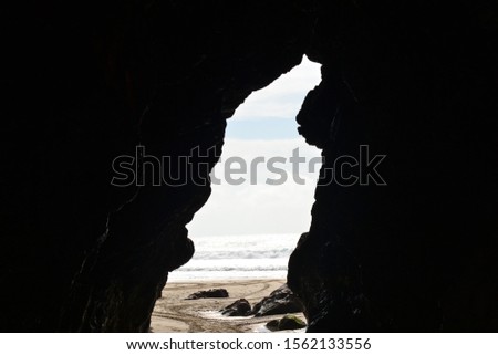 view from a cave of a calm sea