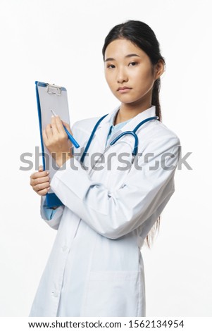 Medical coat with otoscope woman narrow eyes documents doctor