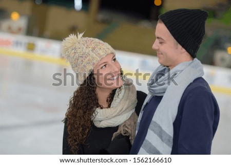 a couple in an ice rink