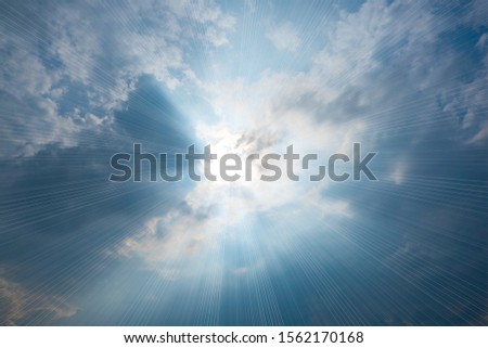 The sky has the light of the sun; the sky is blue; there are small and large clouds alternating and moving slowly; with the sunlight passing; creating a miraculous abstract shape; a hot day in the mor