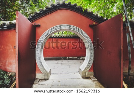 Round gate in red wall passage, color toned picture, Wuhou Temple, Chengdu, China.